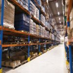 interior-large-distribution-warehouse-with-shelves-stacked-with-palettes-goods-ready-market